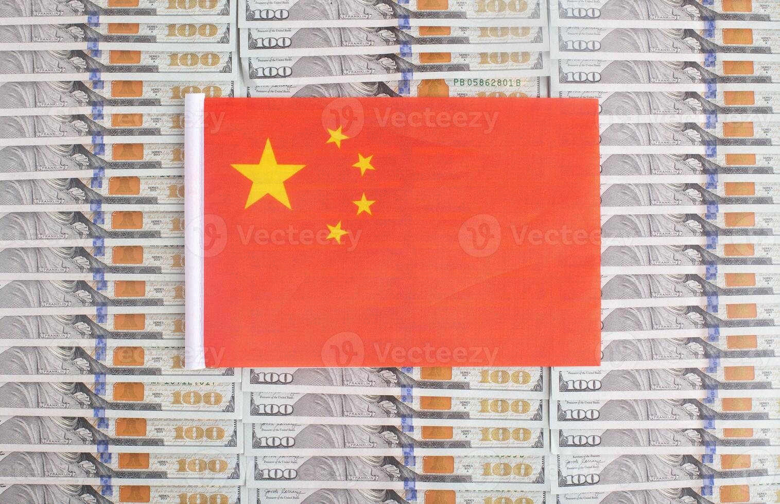China flag on a background from dollar banknotes. Concept of the relationship of the money of china in relation to the dollar, the country's economy, financial photo