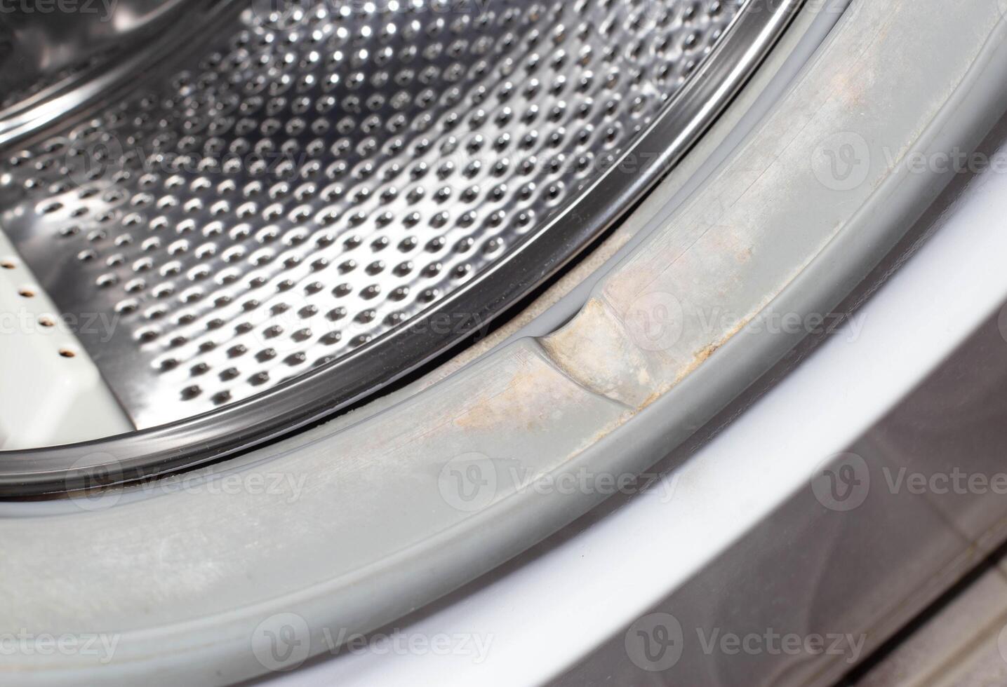 Dirt and fungus from moisture on the sealing gum of the washing machine drum. Washing machine cleanliness and care concept photo