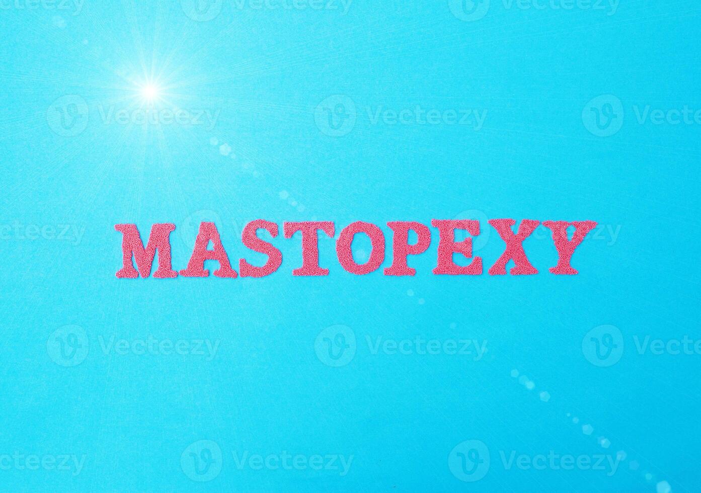 The word mastopexy in red letters on a blue background. The concept of aesthetic surgery in changing ptosis of the mammary gland. Correction of the shape and volume of the female breast, medical photo