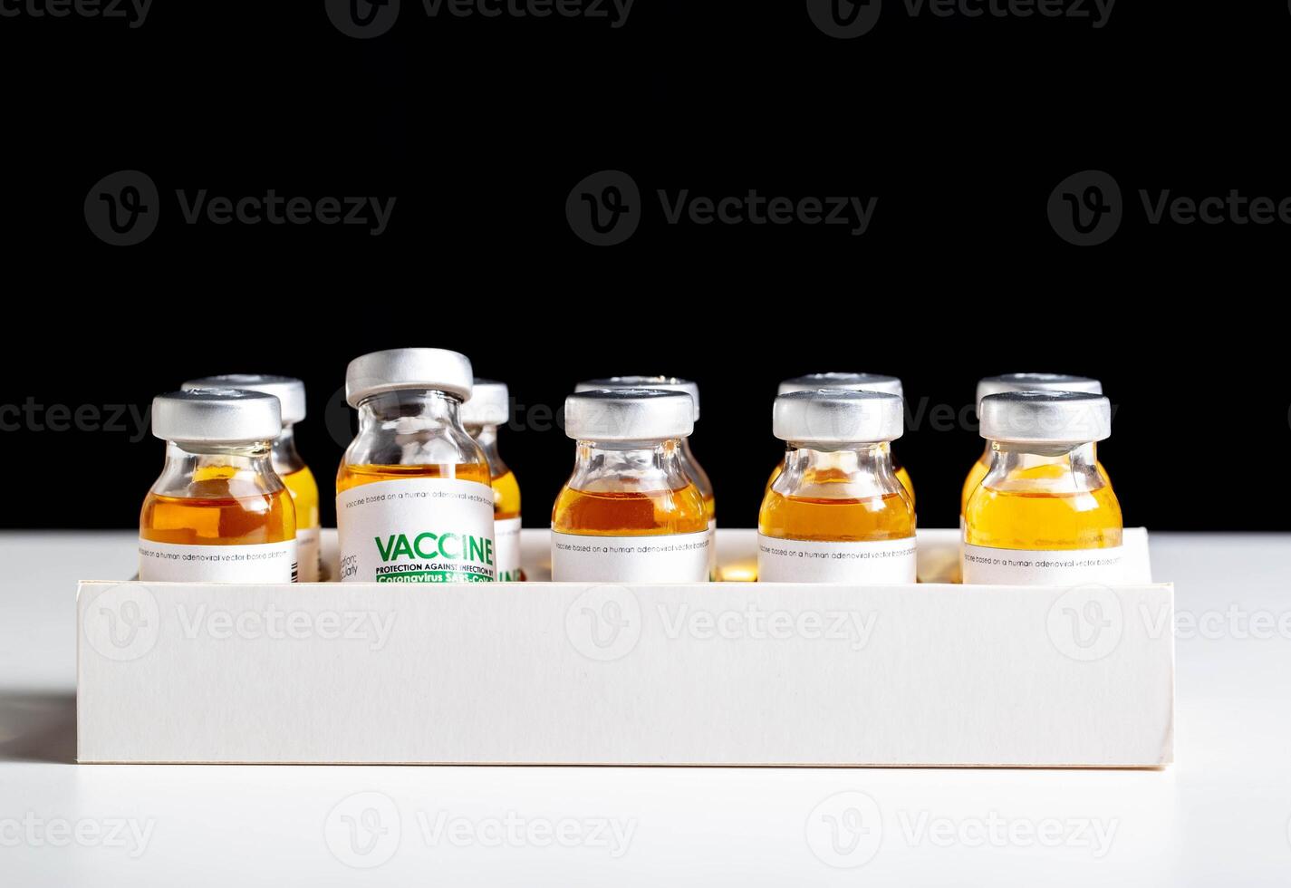 Vials of coronavirus medicine are in packaging on a white background. Vaccine test concept in a laboratory, macro photo