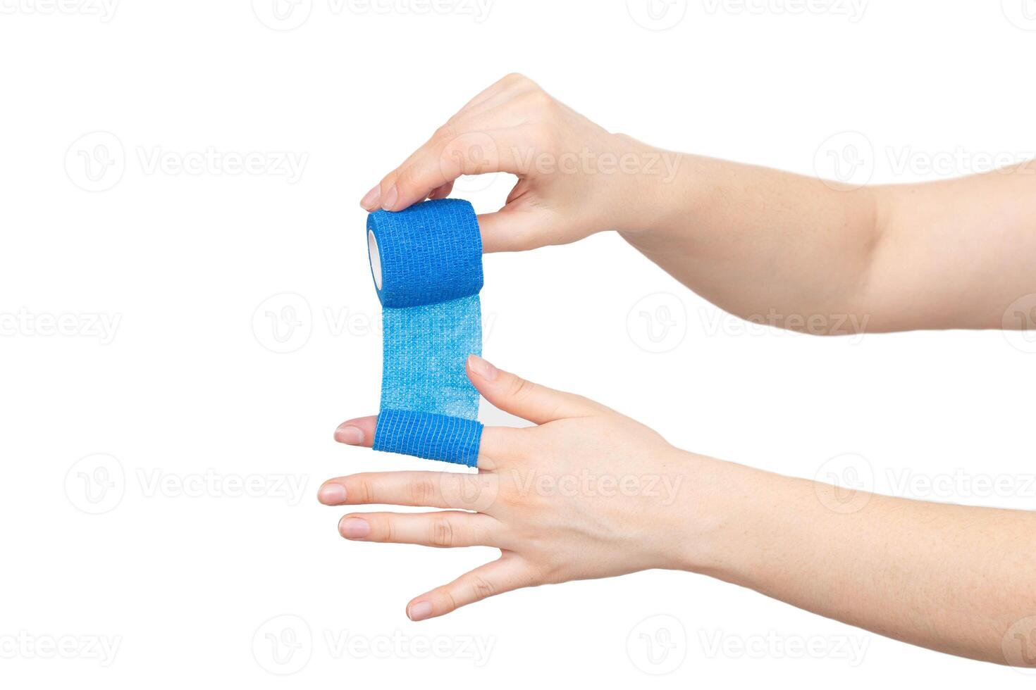 man winds an elastic bandage on his hand on a white background, isolate. The concept of fixation of the digital cleft in case of dislocation, isolated photo