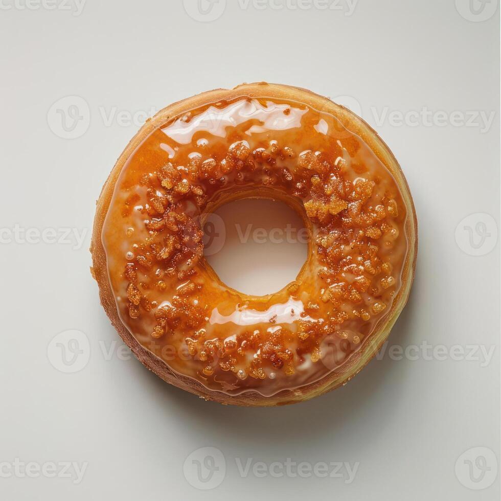 A round glazed donut with a single hole in the center. photo