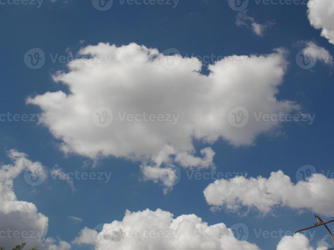 A large white cloud on clear blue skies photo