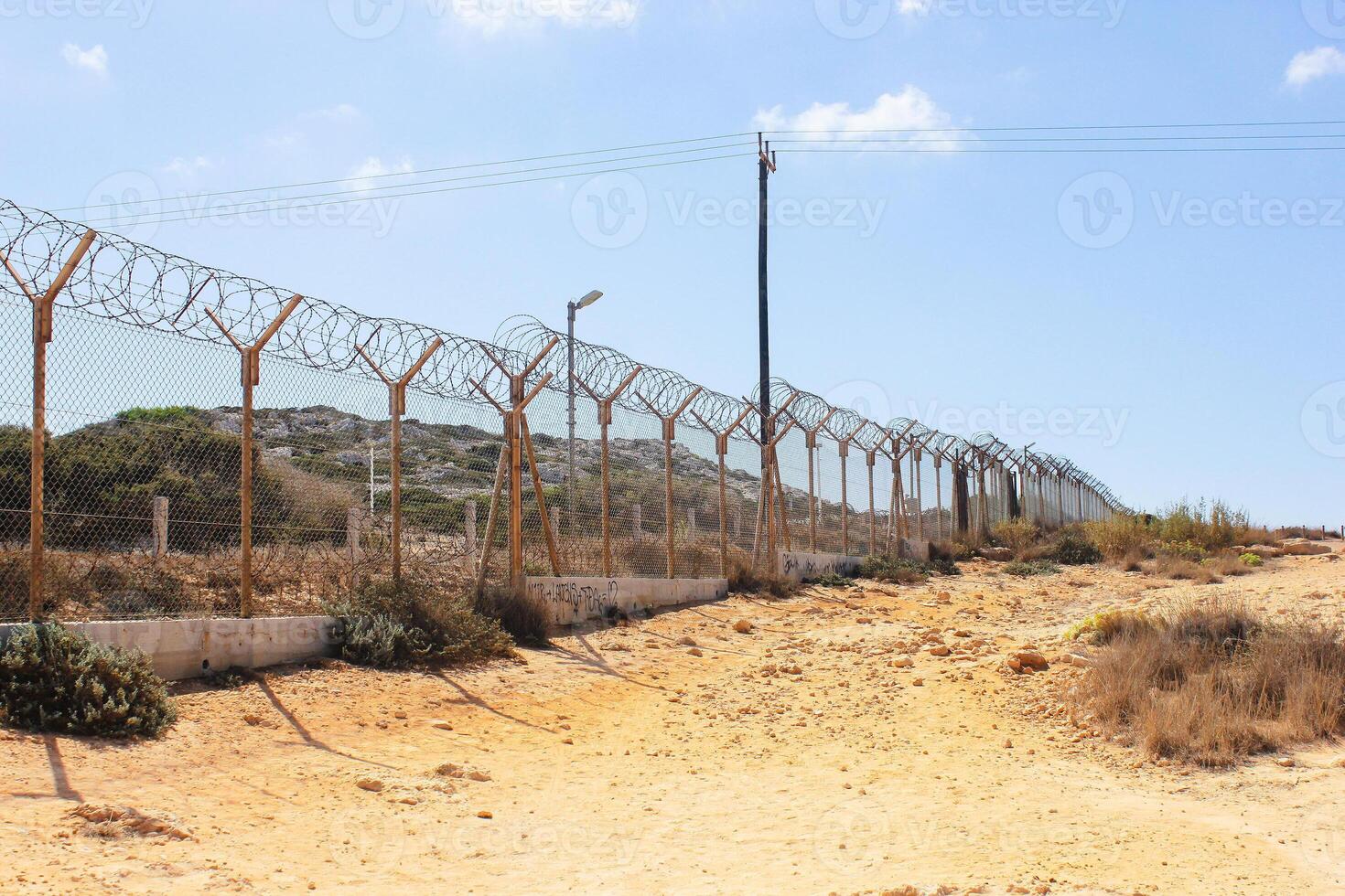 Protected area on Capo Greco in Cyprus. Barbed wire in deserted area. photo