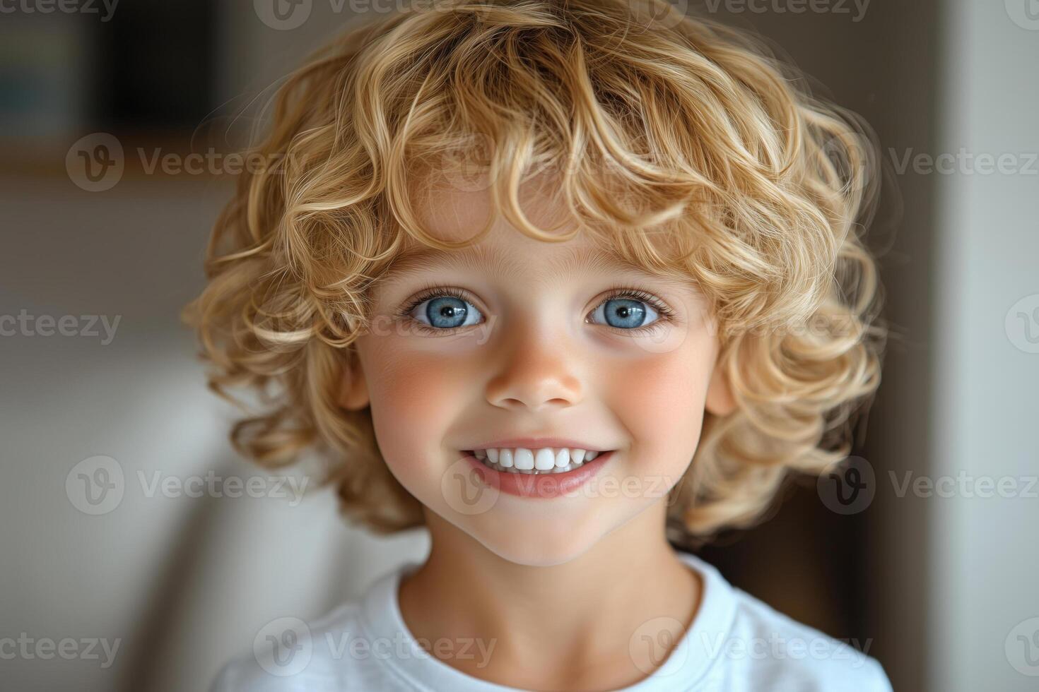 Smiling blond five year old boy looks handsome at camera. Cheerful and friendly atmosphere. photo