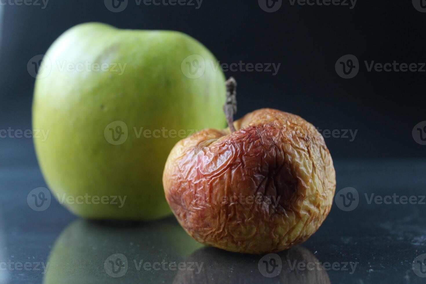 apple ugly spoiled and beautiful good on a black background copyspace photo