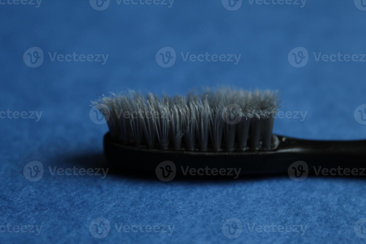 toothbrush on a blue background, side view. How to choose the right toothbrush photo