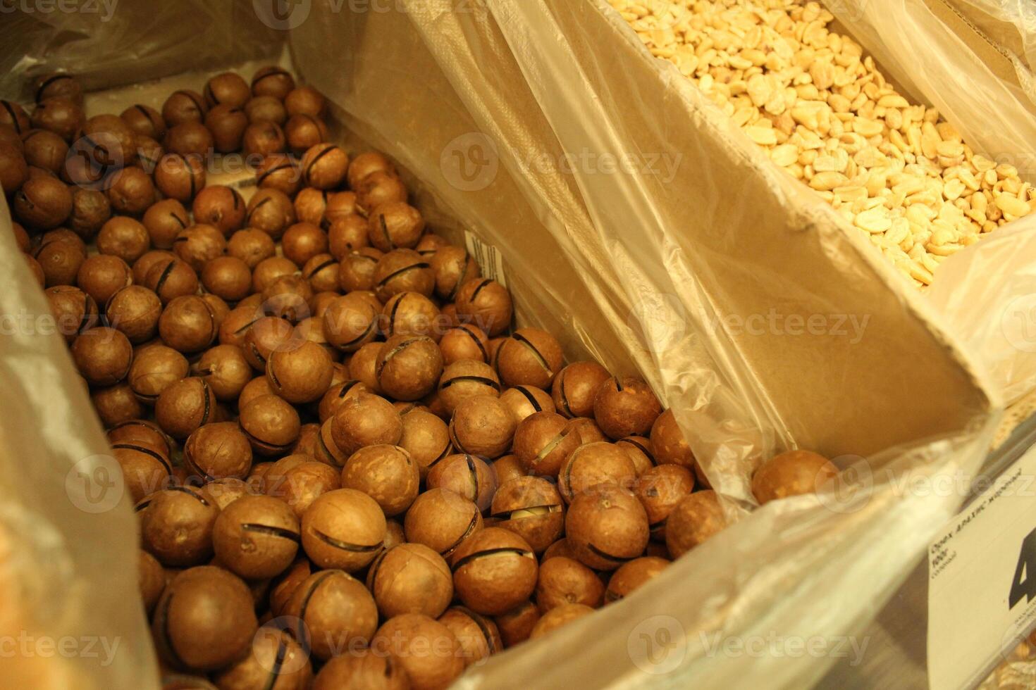 Macadamia nut in a box at the store. Availability of nuts. Benefits and harms of nuts photo