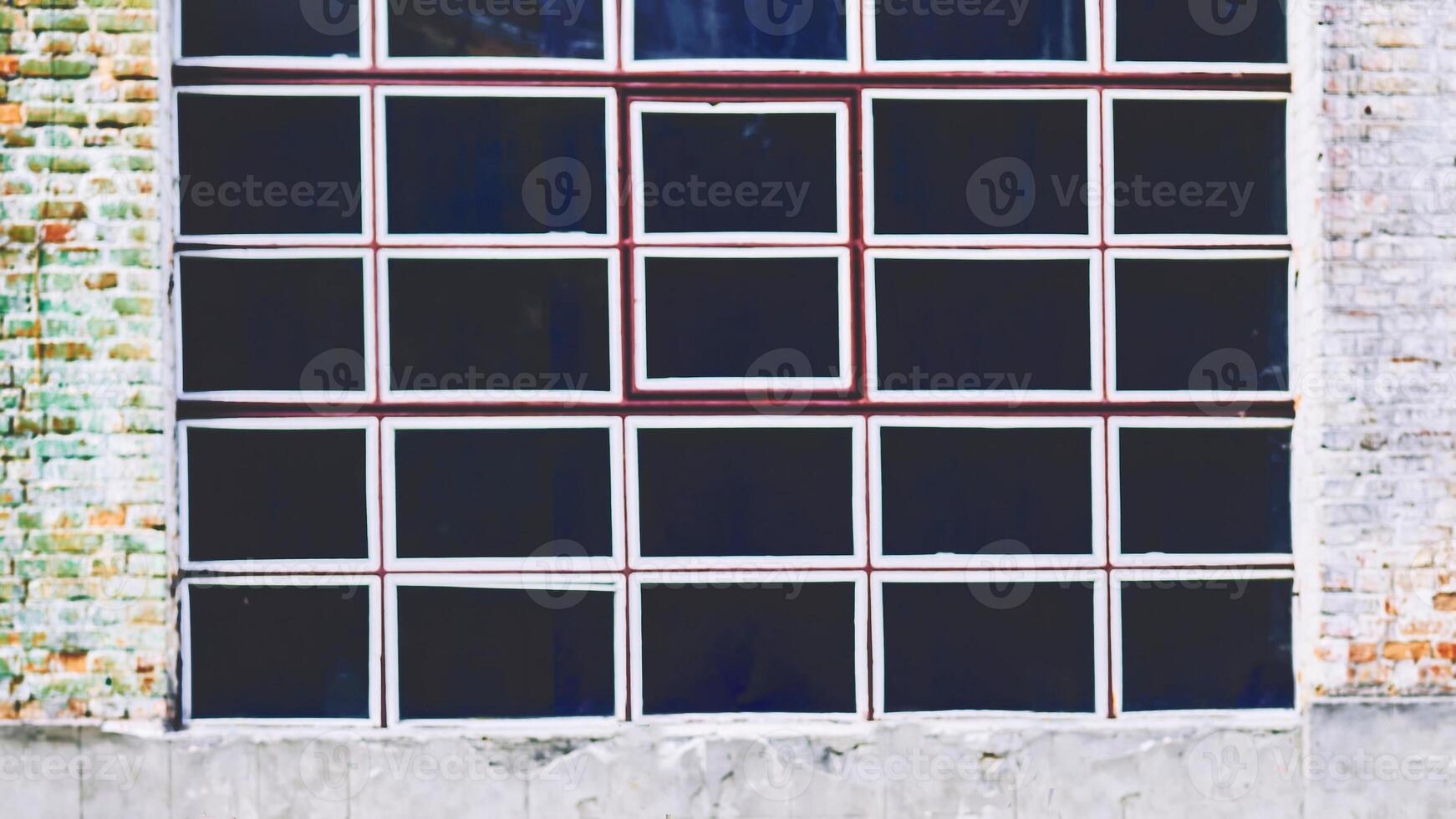 Black window with white frames on vintage old brick wall photo