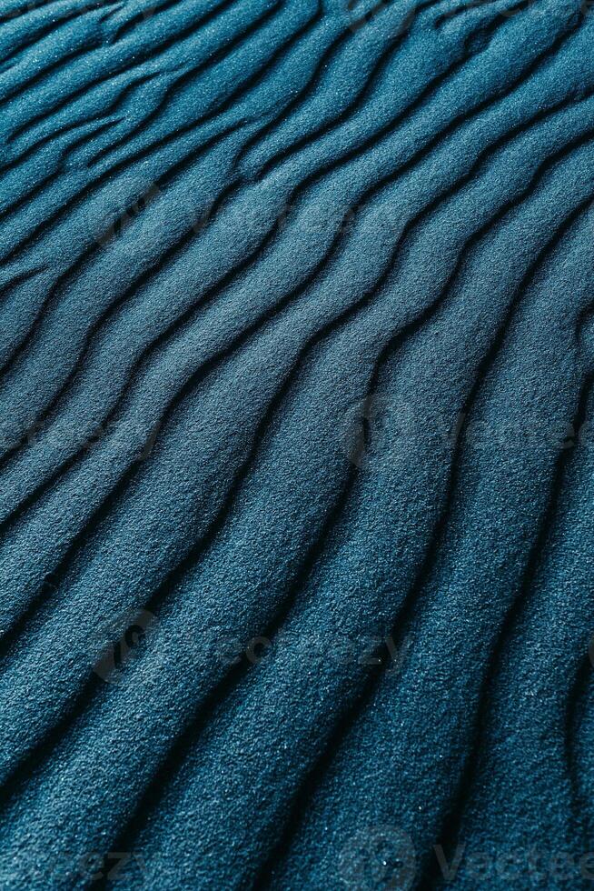 a close up of a sand dune with waves photo