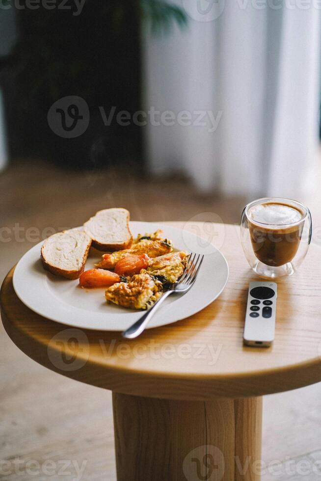 a plate of food on a table with a remote control photo
