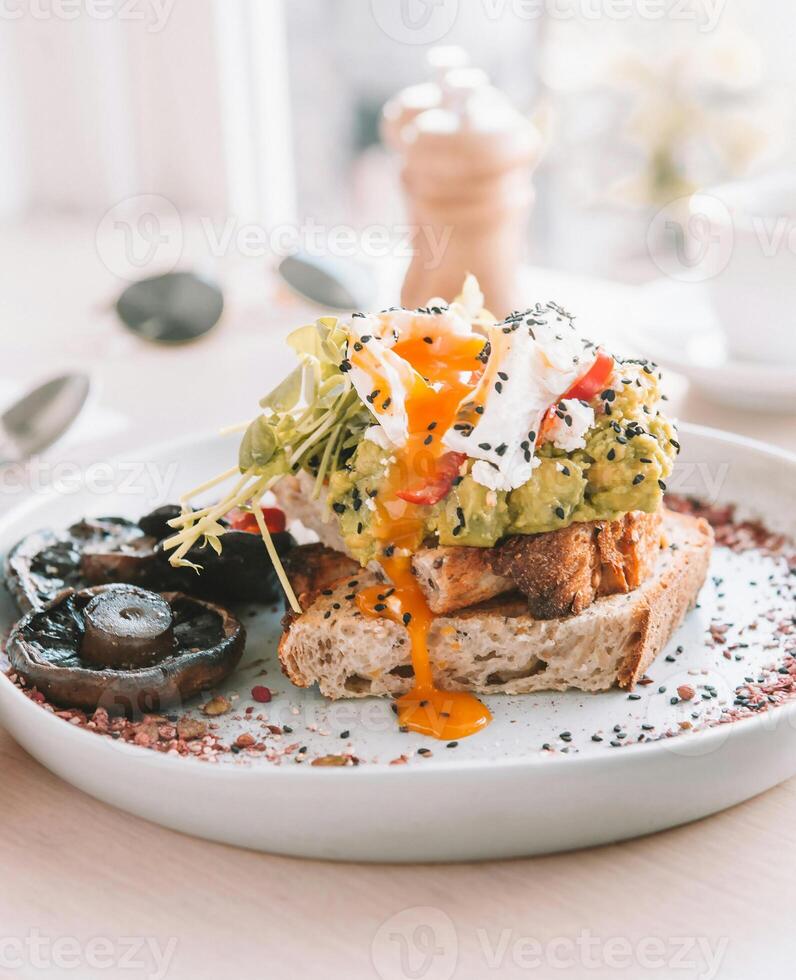 a plate topped with an egg avocado and mushrooms photo