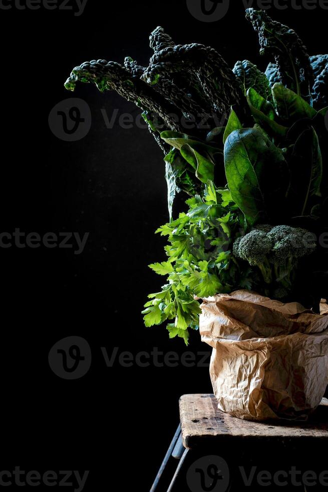 a bunch of green vegetables in a paper bag photo