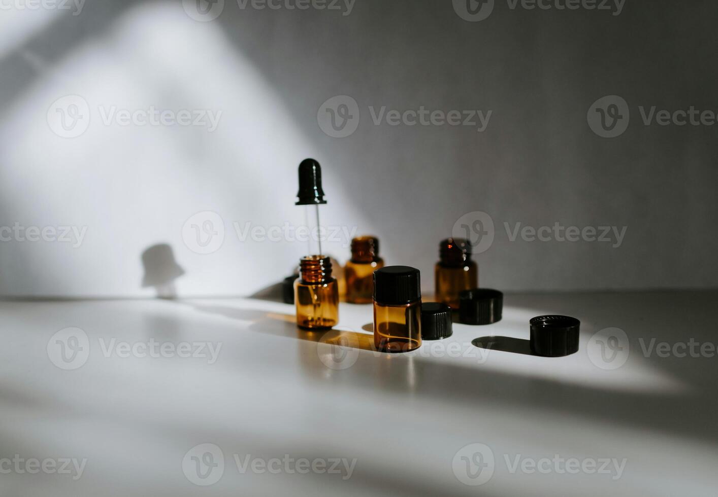 essential oils on a table with shadows photo