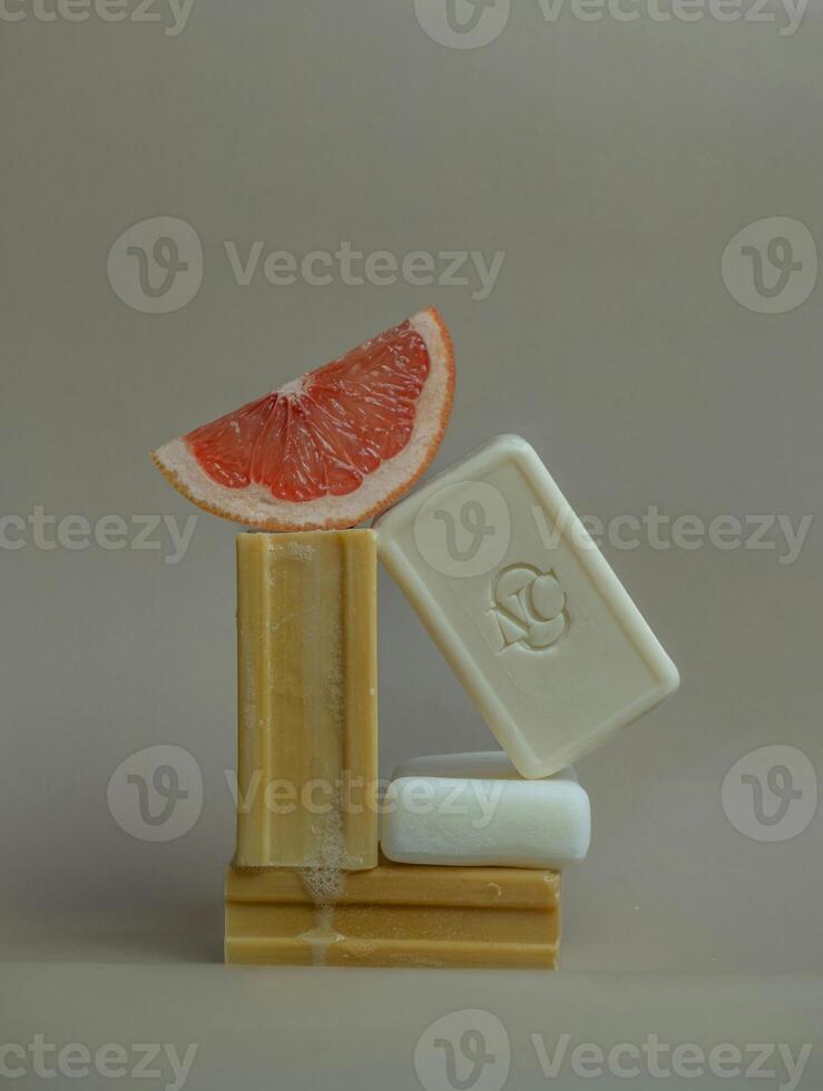 a soap bar with a grapefruit on top photo