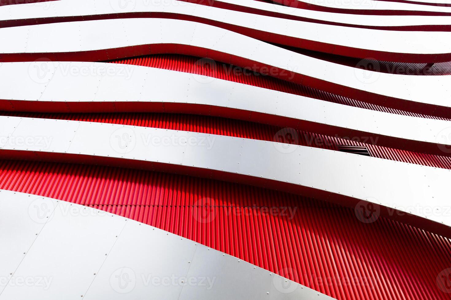 a red and white building with a curved wall photo