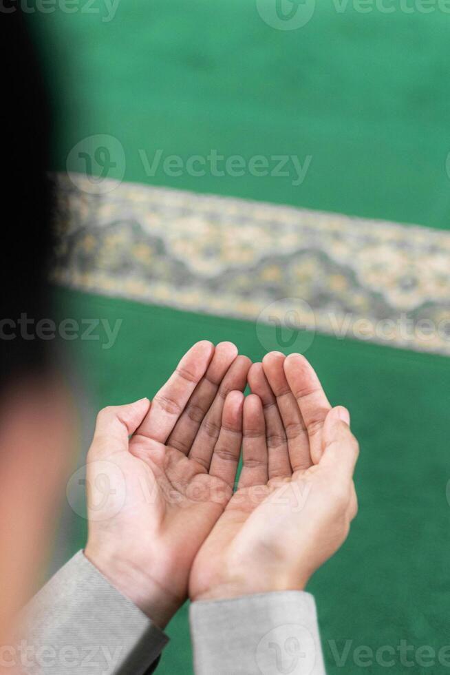 hands of muslim praying in mosque photo