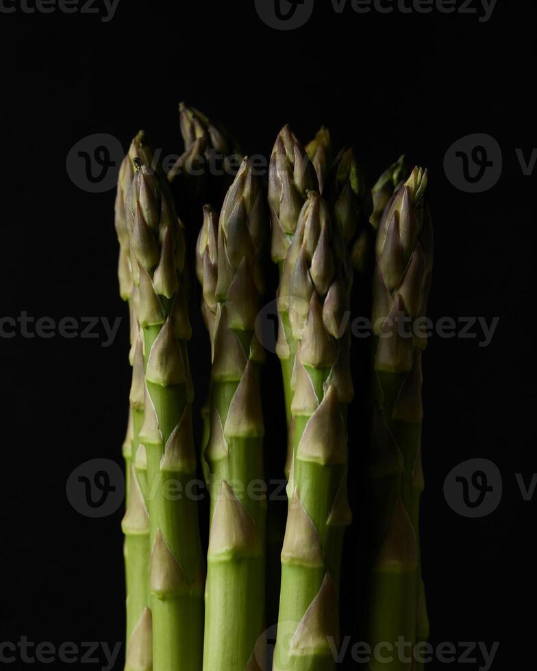 a bunch of asparagus on a black background photo