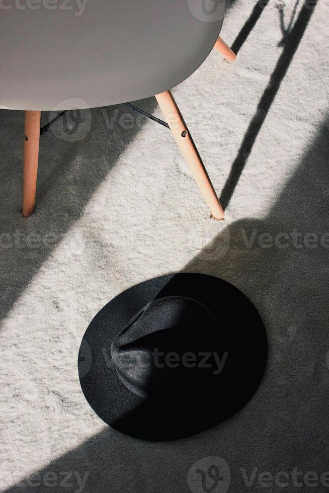 a hat on the floor under the table on white background photo