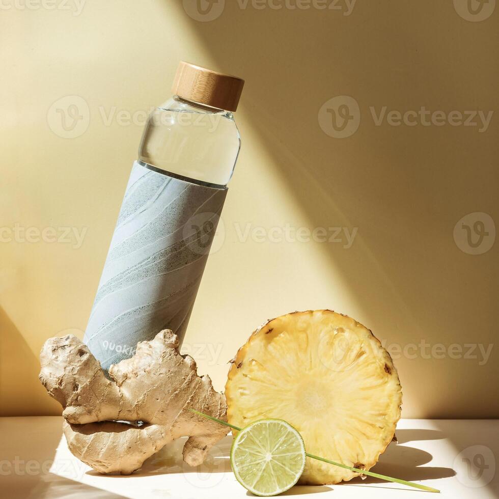 a bottle of water next to a pineapple and ginger photo