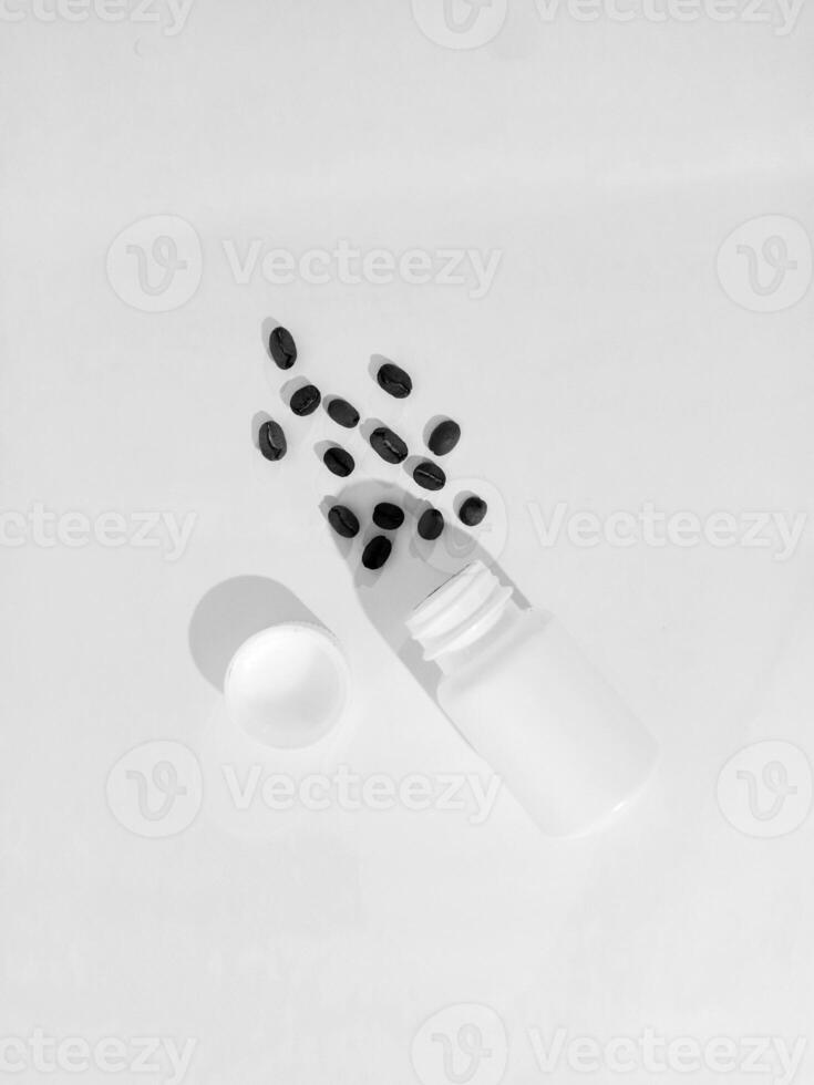 a bottle of pills and a spoon on a white surface photo