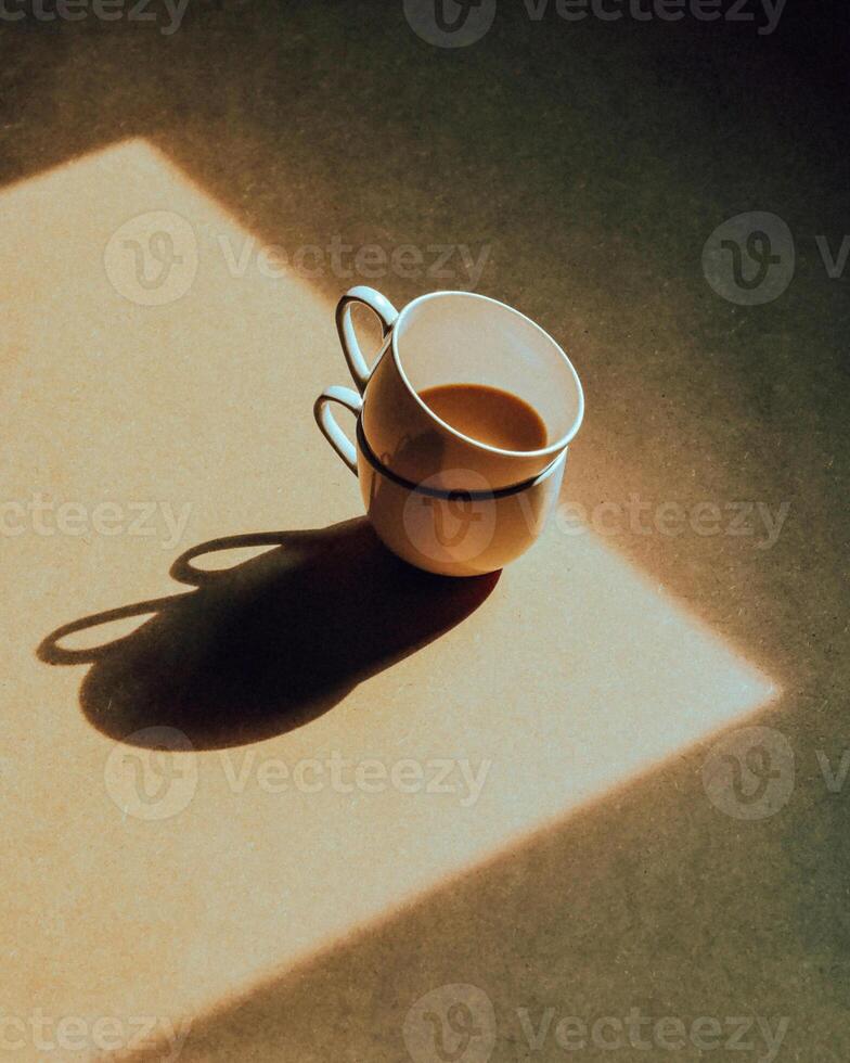 a coffee cup and saucer on a table photo