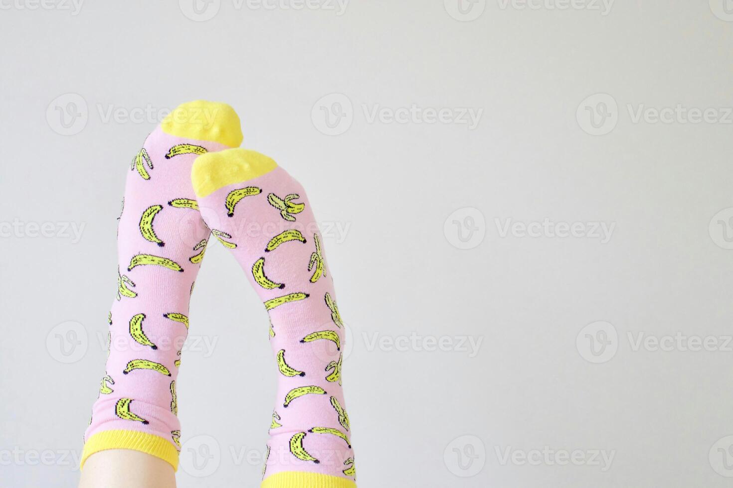 a person wearing a pair of socks with bananas on them photo