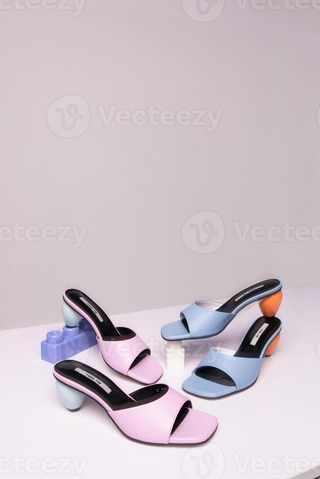 three pairs of colorful sandals on a white surface photo