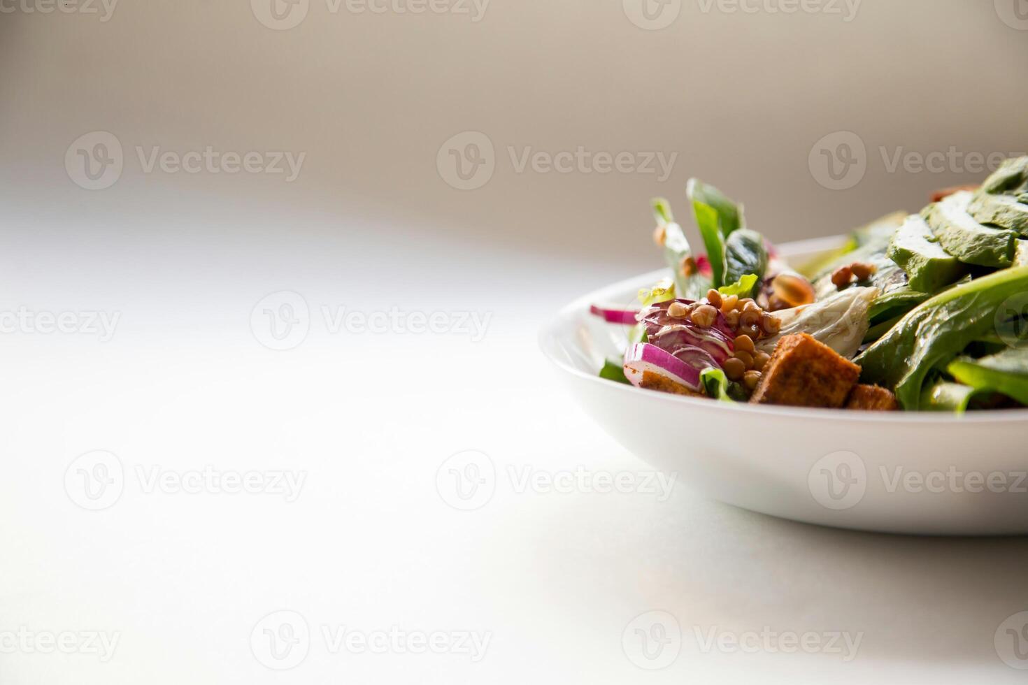 a white bowl with a salad in it photo