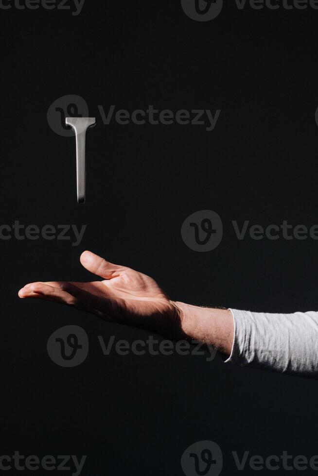 a person holding a t-shaped object in their hand photo