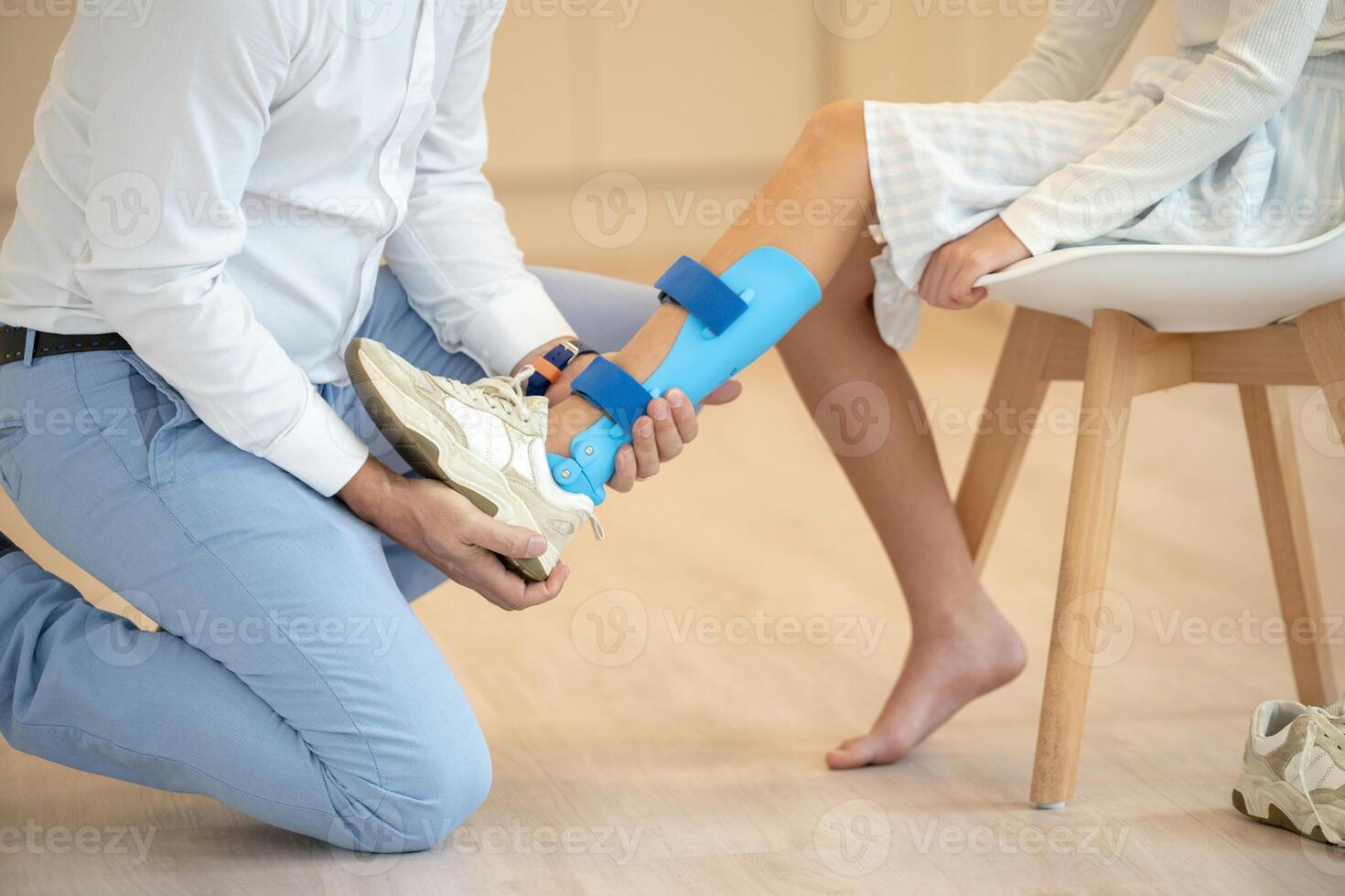 a man is putting on a shoe with a blue bandage photo