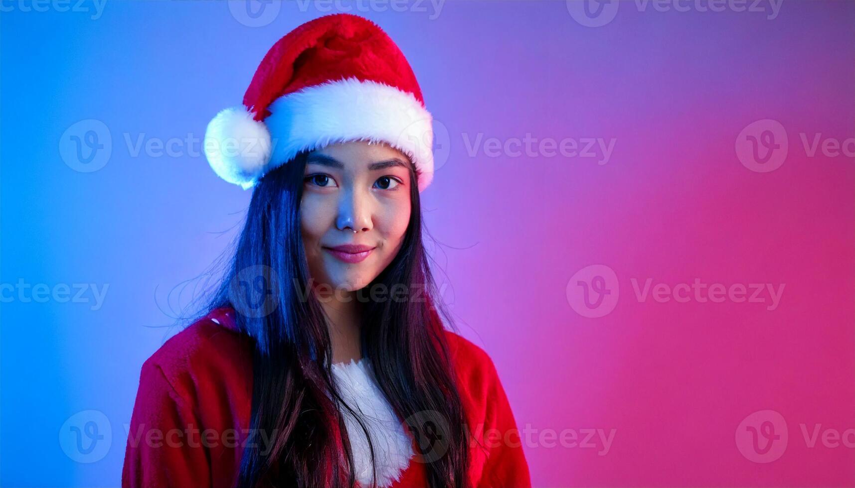 A woman wearing a santa hat and posing for the camera photo