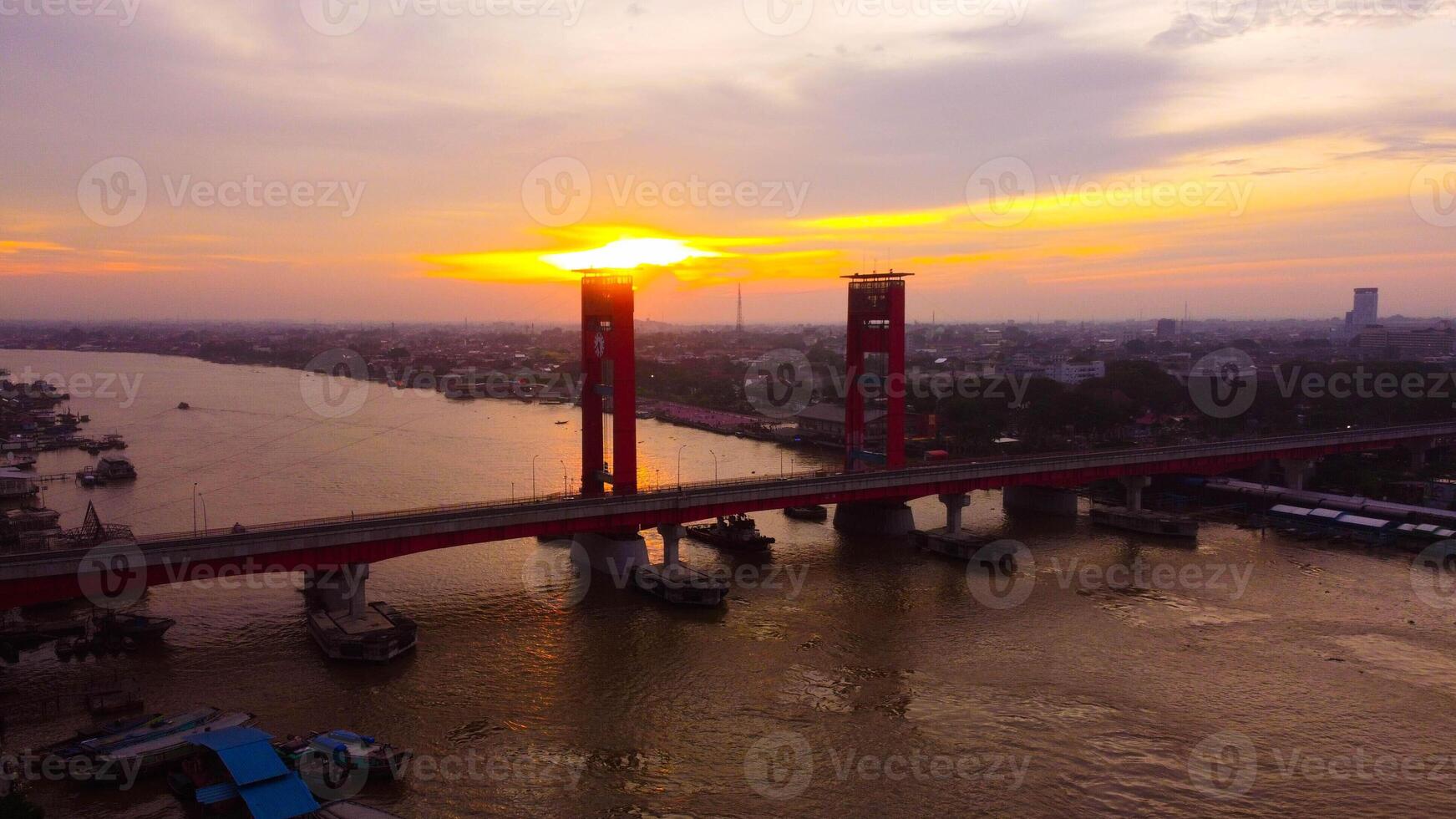 Majestic Ampera Bridge, a landmark of Palembang, towers over the river in the city center. Perfect for showcasing urban beauty and culture. photo