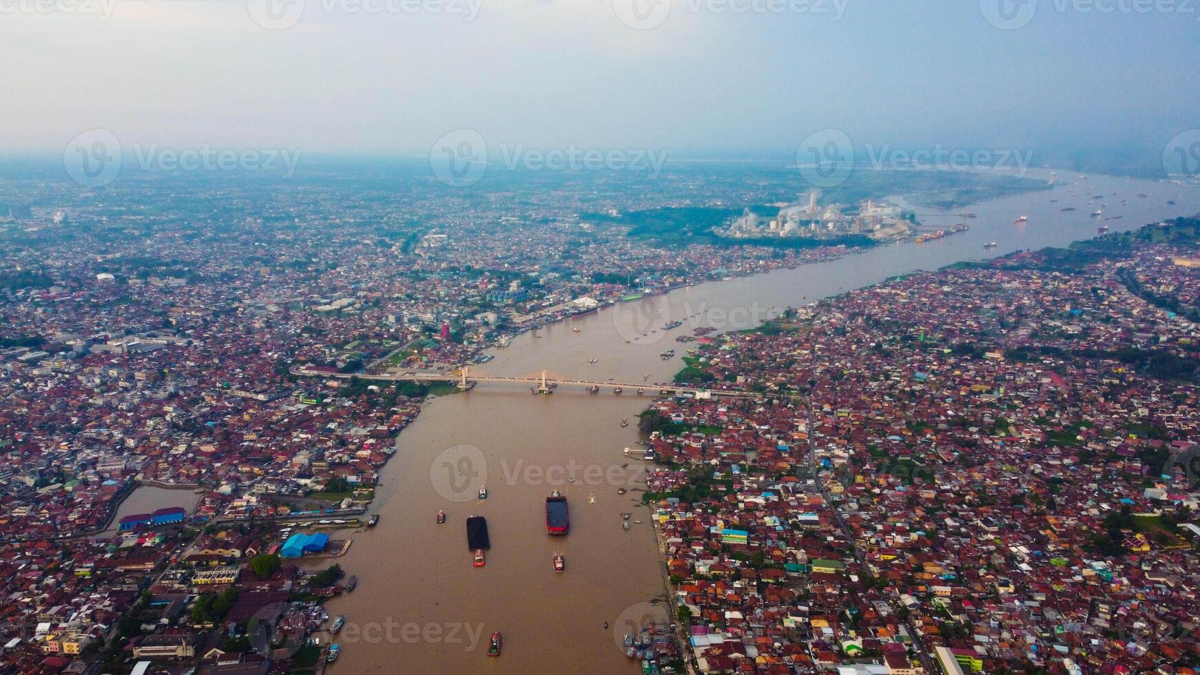 Majestic Ampera Bridge, a landmark of Palembang, towers over the river in the city center. Perfect for showcasing urban beauty and culture. photo