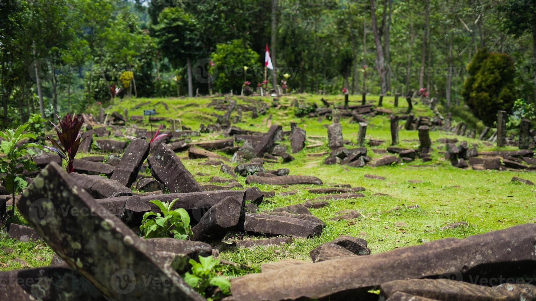 Gunung Padang, also known as Pyramid Mountain, stands in West Java, Indonesia. This historical site, surrounded by dense green vegetation photo