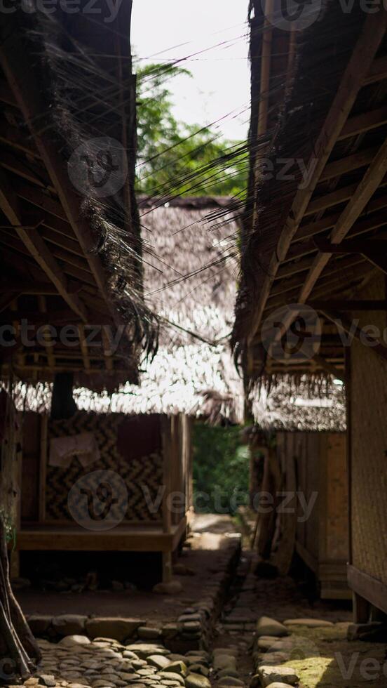 In Baduy Luar, children joyfully play soccer on a simple field in front of their homes. Their laughter fills the air, celebrating community spirit. photo