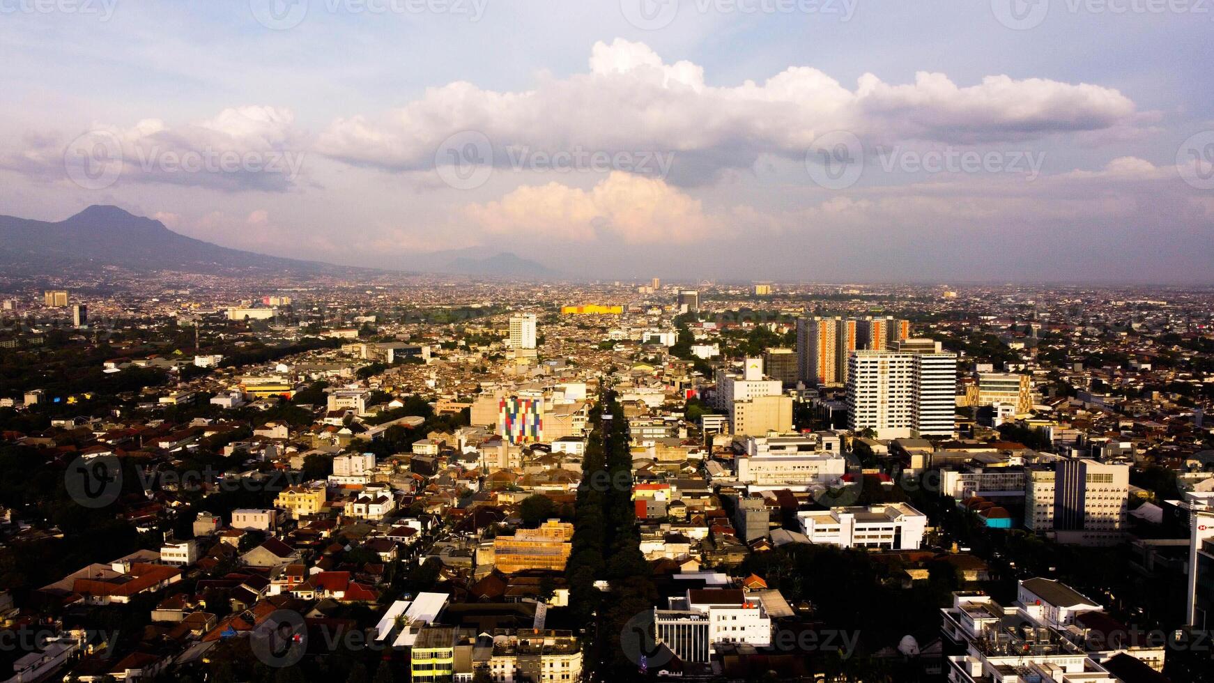 An aerial view of Braga Street captures the bustling urban landscape of Bandung in the evening. photo