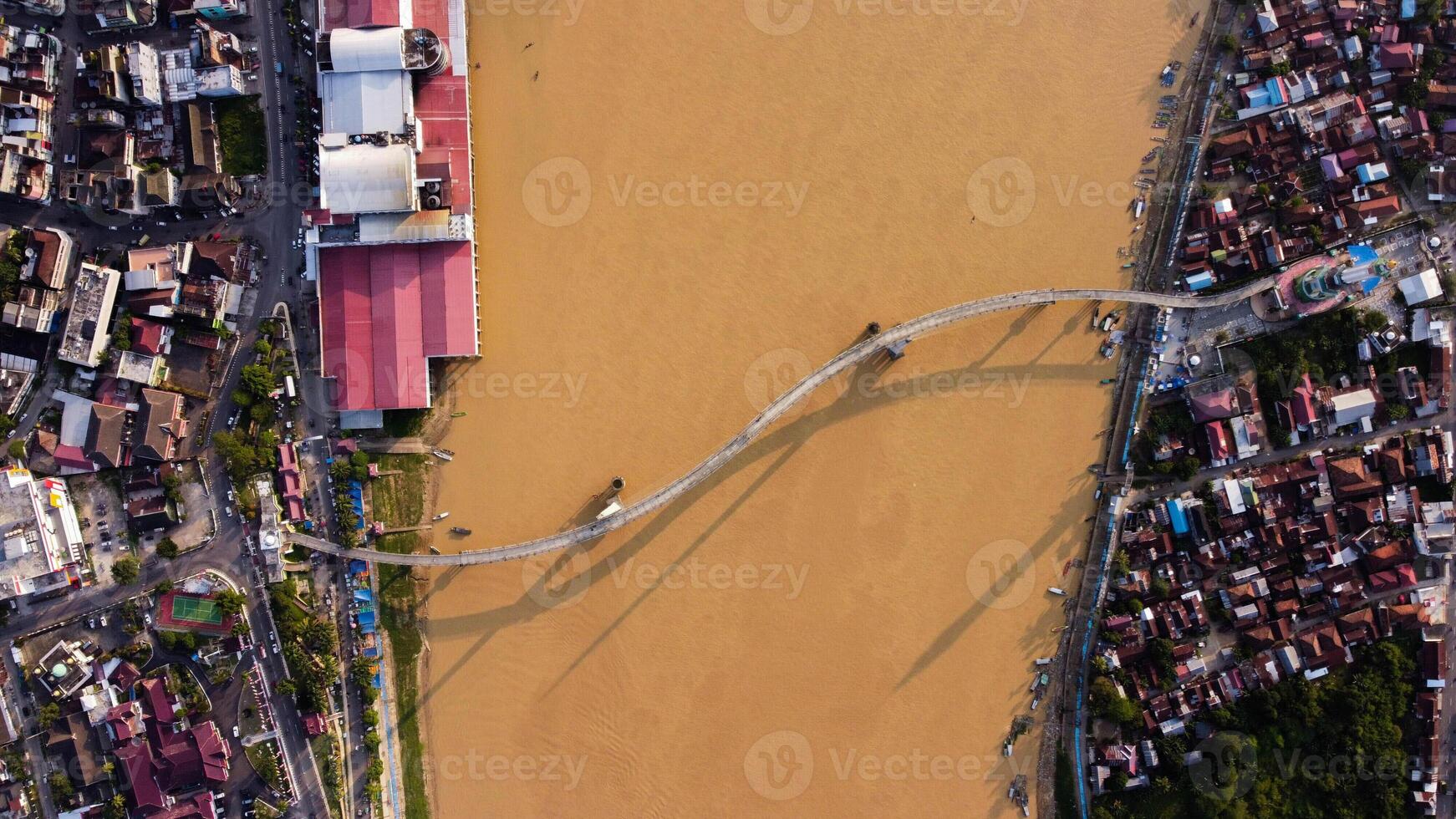 Aerial View of Gentala Arasy Bridge at Sunset with Drone Track In One of the icons in Jambi, Indonesia. photo