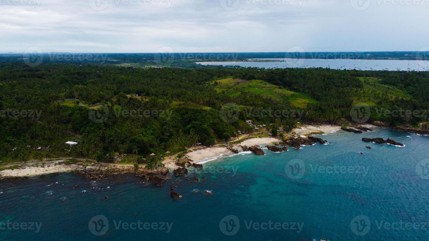 Aerial view of steep cliffs on Bali beach with blue waters in Indonesia photo