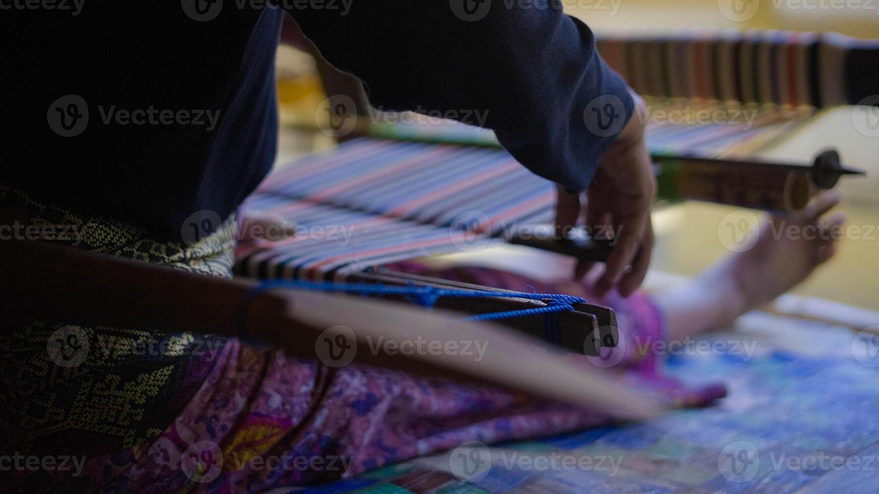 Colorful of Kain Tenun, an Indonesian traditional hand woven fabric from West Nusa Tenggara or Lombok, hanging for sale in Sade village as souvenirs photo