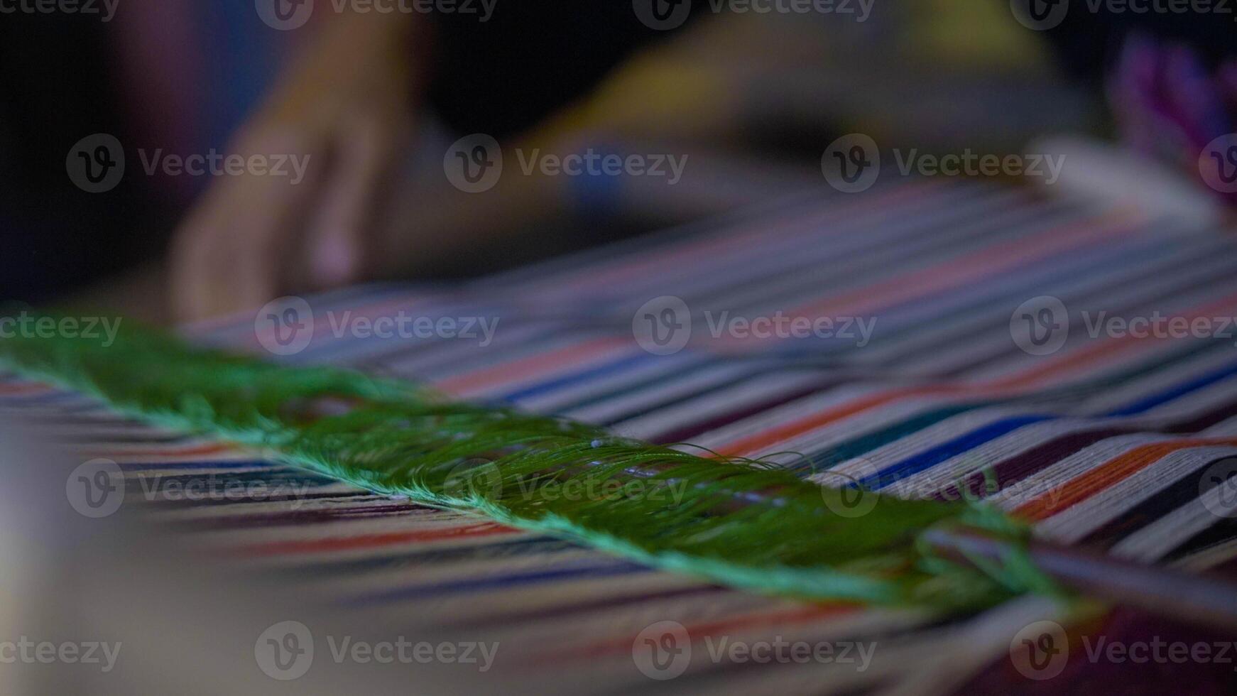 Colorful of Kain Tenun, an Indonesian traditional hand woven fabric from West Nusa Tenggara or Lombok, hanging for sale in Sade village as souvenirs photo