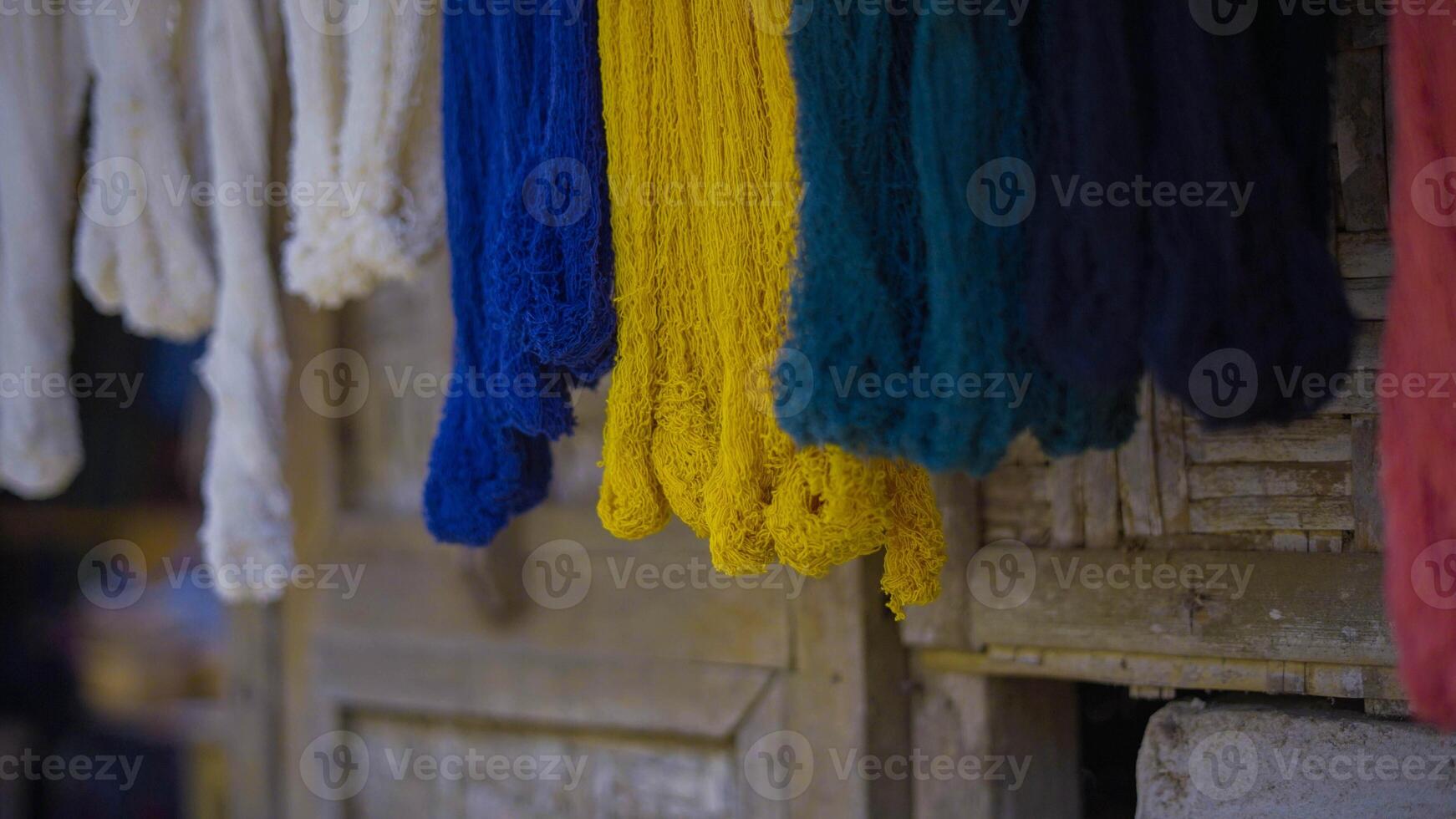 Colorful of Kain Tenun, an Indonesian traditional hand woven fabric from West Nusa Tenggara or Lombok, hanging for sale in Sade village as souvenirs photo