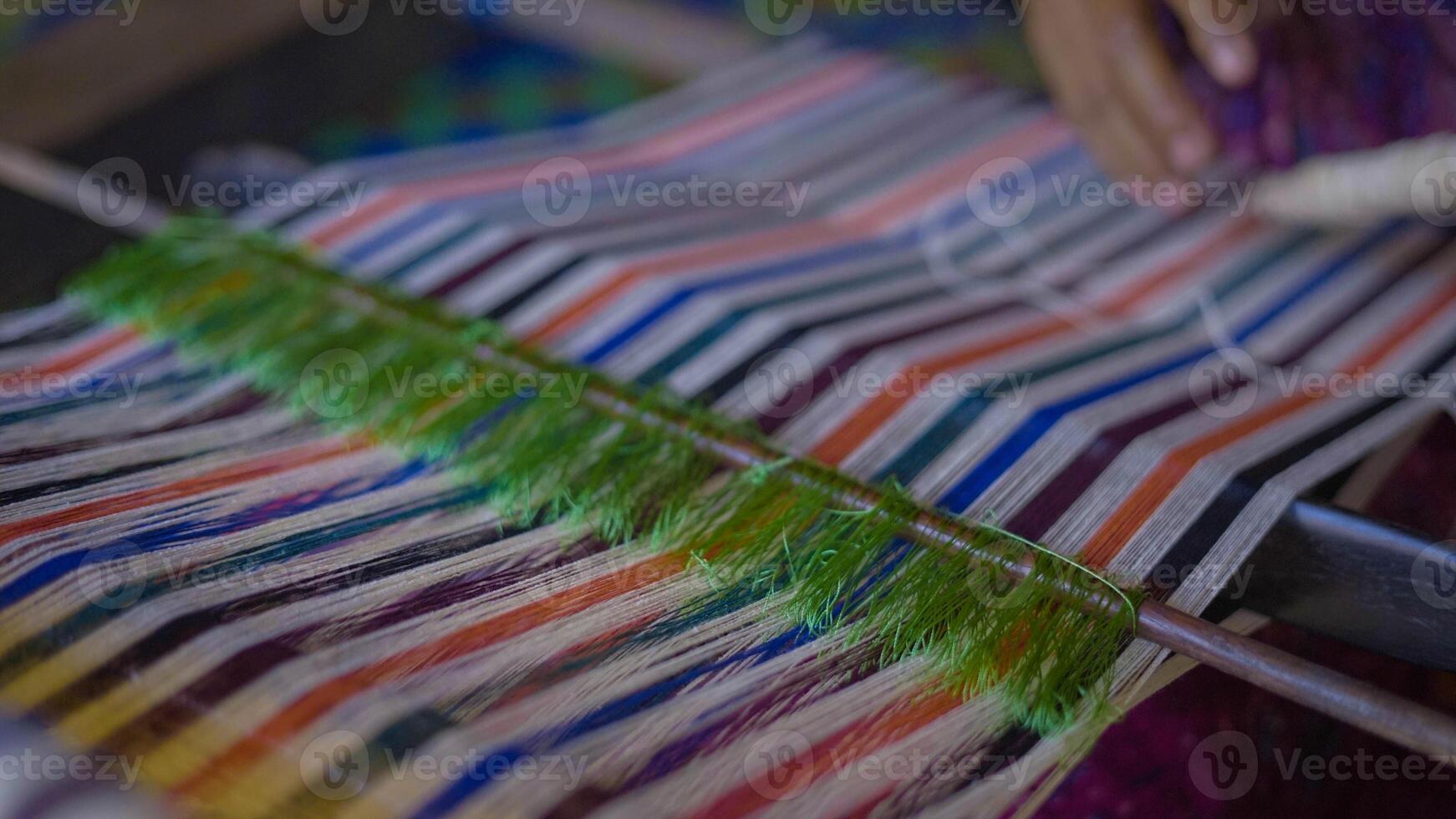 Colorful of Kain Tenun, an Indonesian traditional hand woven fabric from West Nusa Tenggara or Lombok, hanging for sale in Sade village as souvenirs photo