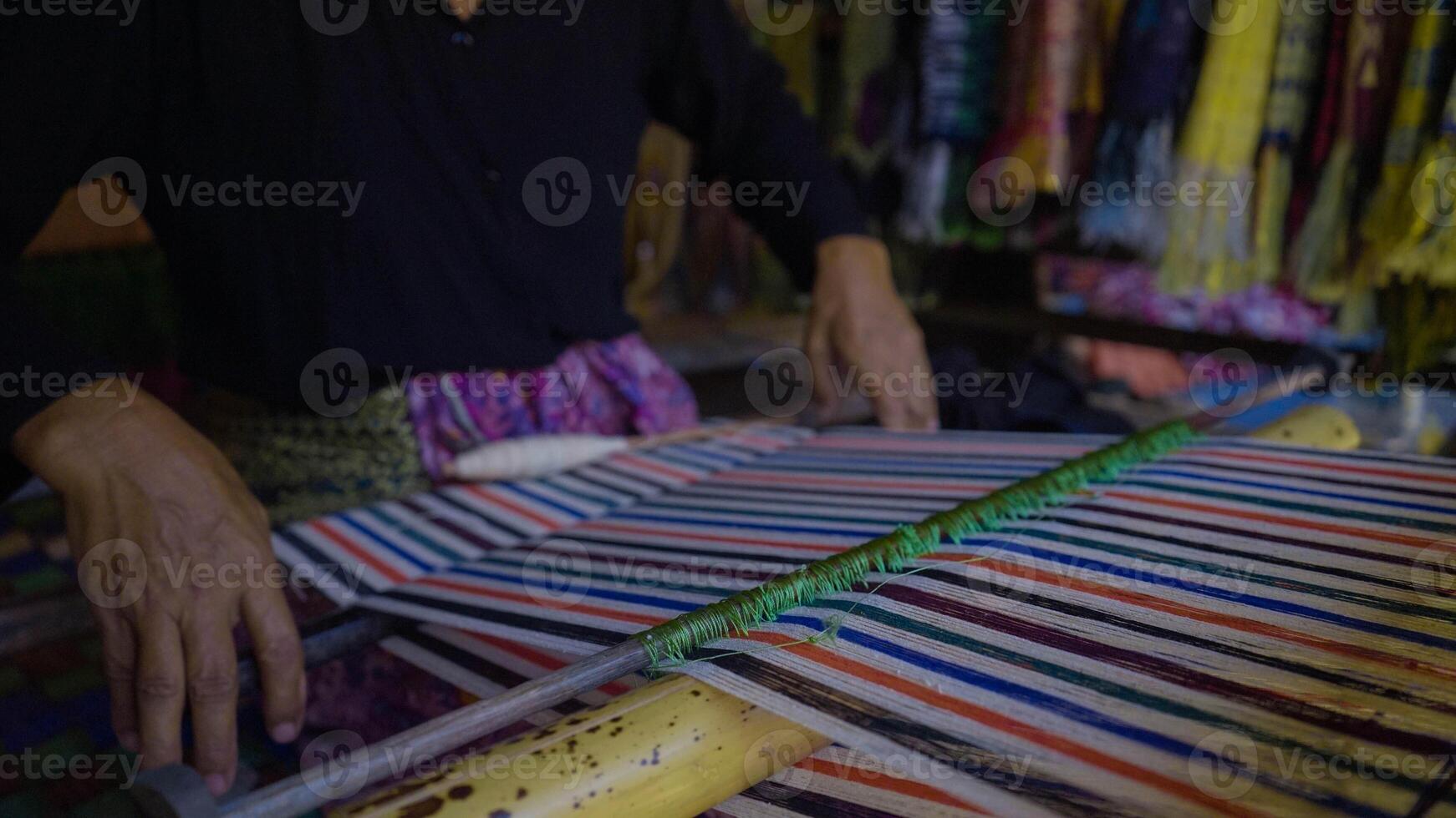 Colorful of Kain Tenun, an Indonesian traditional hand woven fabric from West Nusa Tenggara or Lombok, hanging for sale in Sade village as souvenirs photo