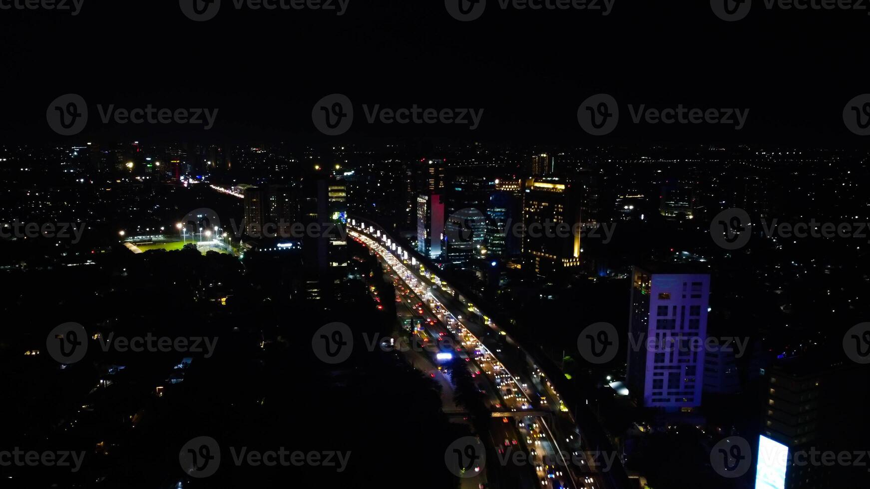 A busy city street with many people and vehicle. Concept of hustle and bustle, with people walking and cars driving in a busy urban environmen photo
