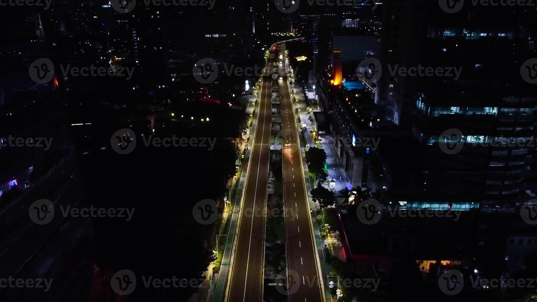 A busy city street with many people and vehicle. Concept of hustle and bustle, with people walking and cars driving in a busy urban environmen photo