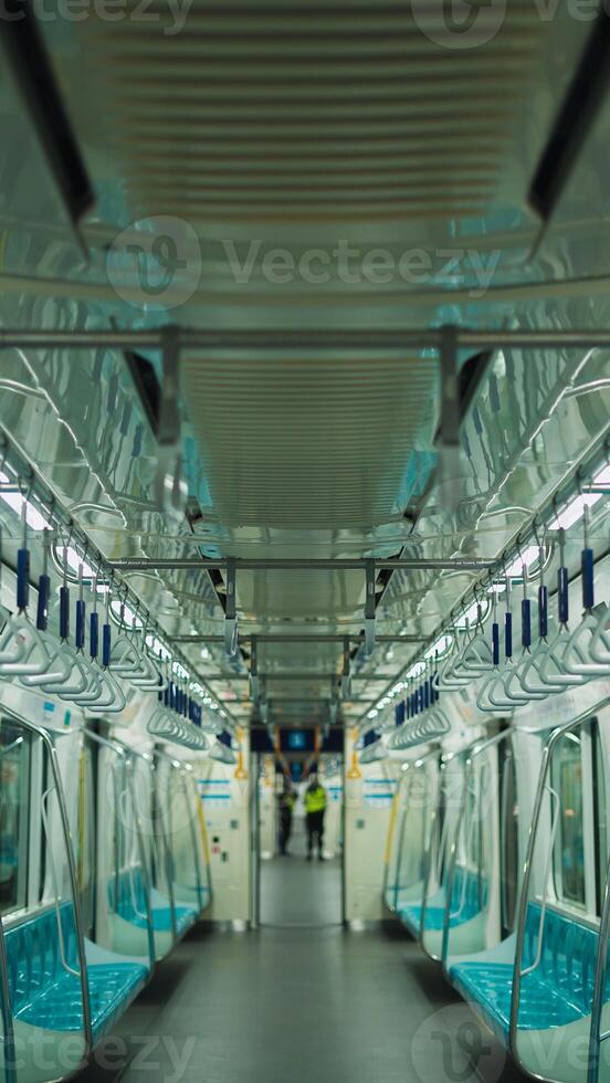 Empty cabin of a modern passenger train. Empty seats inside train cabin, corridor view, no people. Modern european economy class fast train interior. Inside of high speed train compartment photo