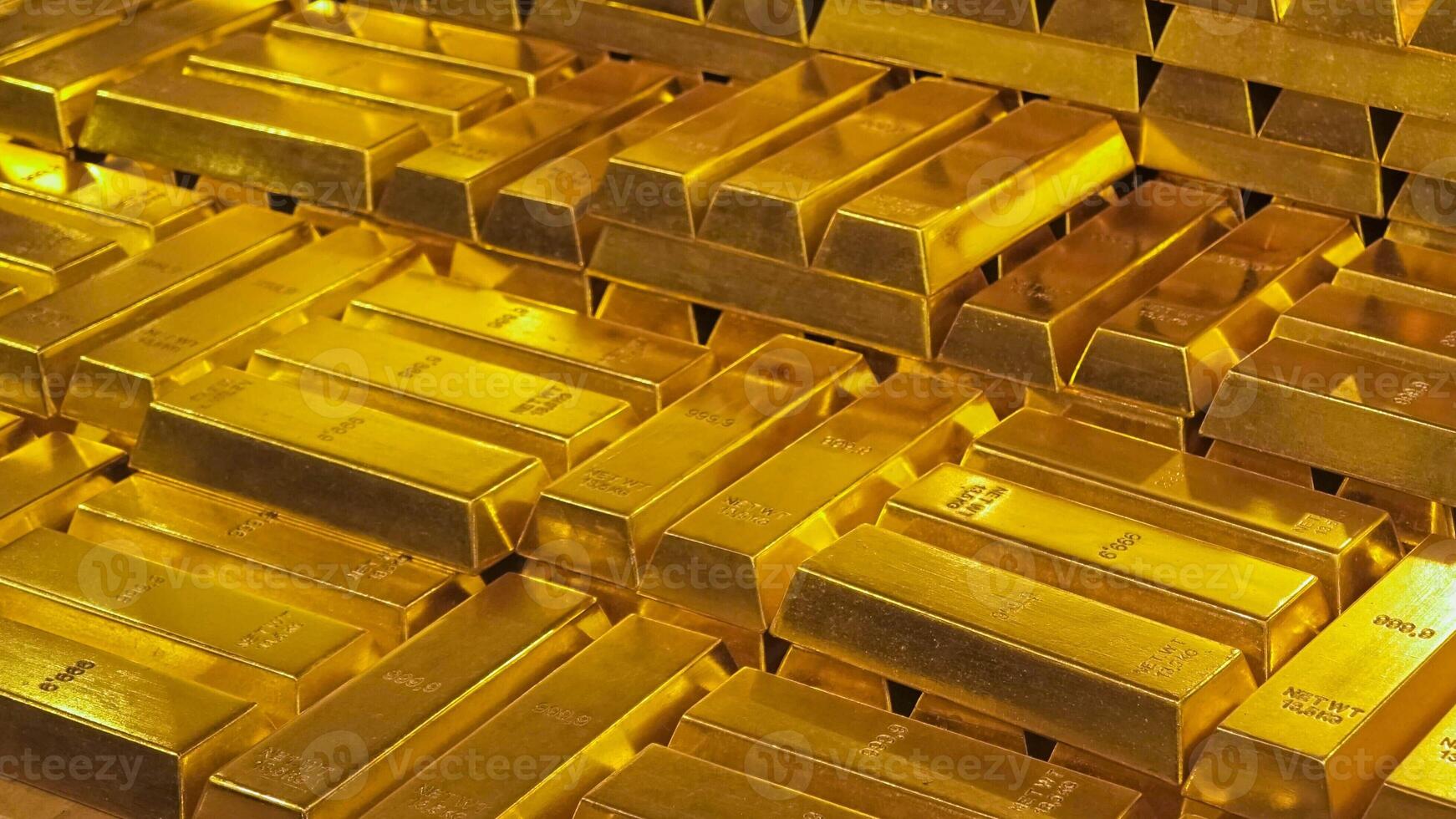 Golden bars of gold. There are many bars of gold in the image. The bars are stacked on top of each other. photo