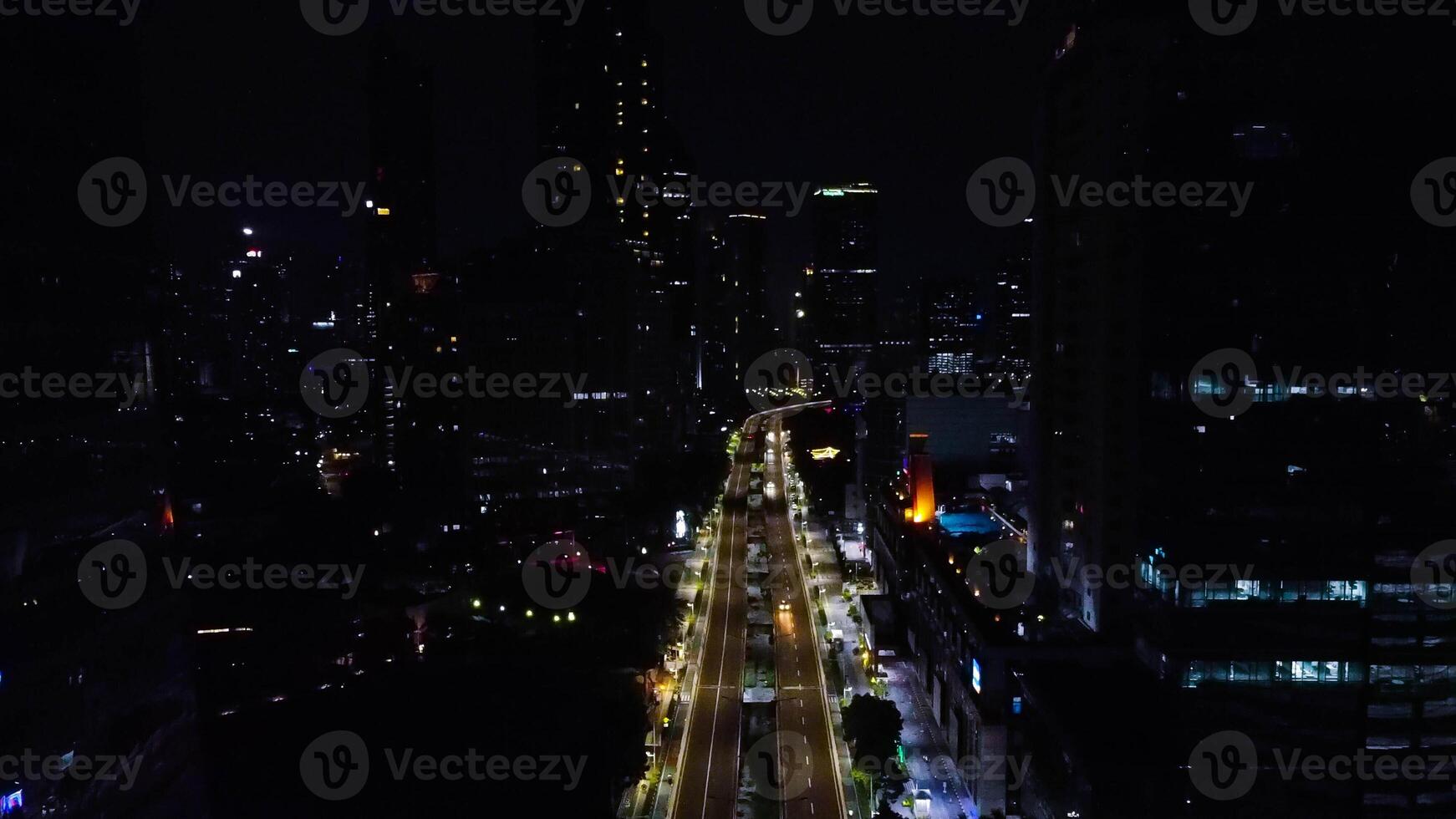 A busy city street with many people and vehicle. Concept of hustle and bustle, with people walking and cars driving in a busy urban environmen photo