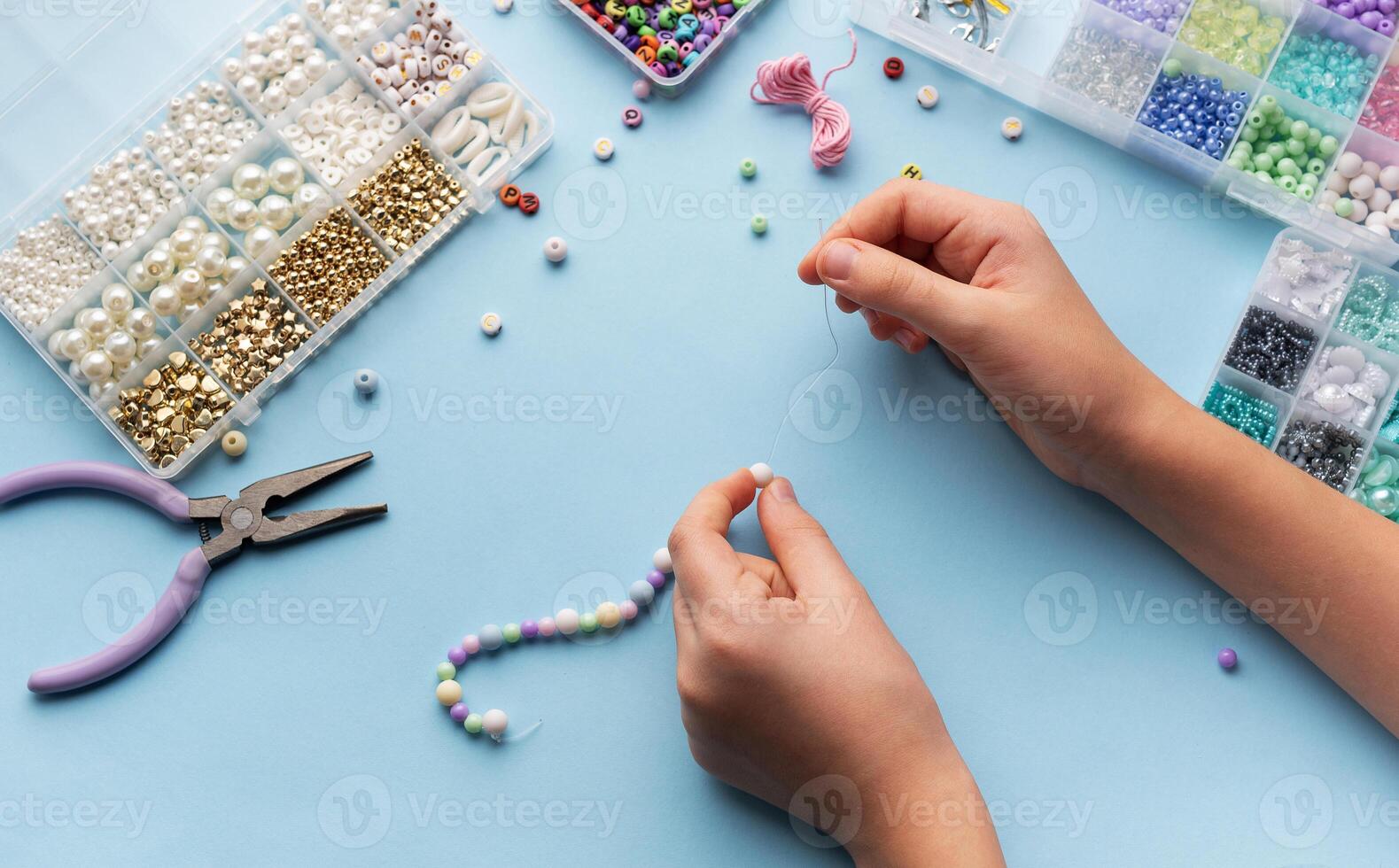 Creating colorful beaded jewelry with vibrant materials on a crafting table photo